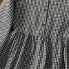 Foto real do novo vestido xadrez artístico retrô japonês de outono de 2026 para mulheres, comprimento médio, modelagem solta, vestido-camisa de manga longa