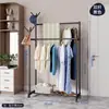 Perchero de pie de hierro forjado con doble barra, simple estante multiusos para ropa para dormitorio del hogar con ruedas