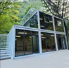 Casa contenedor plegable con muro cortina de vidrio, pisos superior e inferior con terraza, simple y de alta gama, popular entre las celebridades de internet, adecuada para hoteles, casas de huéspedes y oficinas