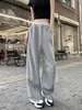 Foto real de los nuevos pantalones de chándal de pierna curva, pantalones anchos de pierna ancha deconstruidos estilo plátano, pantalones casuales de encaje para mujer estilo coreano Miu