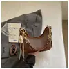 Bolsas de Moda 2026 Nova Bolsa de Mão em Forma de Lua Crescente para Mulheres, Estilo de Nicho, Bolsa de Ombro e Transversal Texturizada, Bolsa de Braço Versátil e Estilosa
