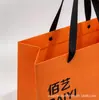 Bolsa de tote de papel recubierto impresión de LOGOTIPO personalizado fabricante venta al por mayor naranja bolsa de regalo bolsa de compras impresión personalizada