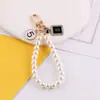 Estilo Nuevo de Primavera Chanel Perla Cadena de Mano DIY Hecho a Mano Bolso Casero Funda para Teléfono Móvil Llavero Accesorios