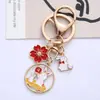Lindo Conejo de Dibujos Animados Colgante Llavero de Aleación Flores Creativas Conejo Luna Etiqueta Accesorios Paquete de Auriculares