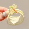 Coloridos coleteros de nuevo estilo 2026, versátiles y dulces, con accesorios de M&M's, anillos de toalla, diseños de dibujos animados y un estilo fresco y lindo, perfectos para accesorios para el cabello de niños