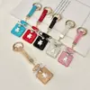 Colgante de llavero de oso con botella de perfume incrustada de diamantes de arcilla, decoración creativa linda de bolsa de fragancia pequeña con diamantes brillantes, llavero de coche