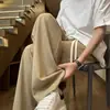 Pantalones casuales de seda de hielo texturizados para hombre, nuevo estilo de verano, pantalones largos de pierna ancha de corte holgado de moda, pantalones deportivos de talla grande