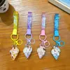 Llavero creativo de concha pequeña con aceite, lindo colgante pequeño de arena movediza líquida, accesorios para bolso, pequeño colgante de regalo, venta al por mayor