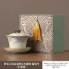Nuevo Estilo Azul y Blanco Rojo Firestone Dorado Pintado Orquídea Peonía Juego de Té Kung Fu Cerámica Tres Piezas Tazón con Tapa para Uso Doméstico Tazón para Preparar Té Venta al por Mayor