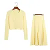Conjunto Tricô Liso Simples e Fashionável Novo Estilo Primavera e Outono Cardigã Torcido Vazado Gola Redonda Saia Midi Evasê Conjunto de Duas Peças para Mulheres