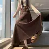 Foto real de la falda de línea A holgada de longitud media con bajo ancho y cinturón, diseño adelgazante, versión coreana, otoño/invierno 2026