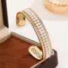 Conjunto de pulsera abierta y anillo de doble fila de perlas y diamantes de lujo ligero estilo francés, anillo versátil de alta gama de nicho bañado en oro