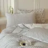 Ropa de cama de algodón puro juego de cuatro piezas estilo sábana hilo de algodón 100% teñido en hilo jacquard a rayas funda nórdica ropa de cama estilo falda de cama de 1.8