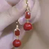 Brincos de Ano Novo 2025 Luz de Luxo Alto Padrão Temperamento Brincos de Pérola Vermelha Adequados para Mulheres no Inverno