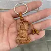 Llavero de imitación de madera de durazno colgante de bolsa de madera tallada puesto de mercancía pequeña colgante de llave de coche al por mayor una generación de cabello