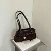 Bolso de axila de diseño de nicho transfronterizo 2026 de moda para mujer, bolso de hombro moderno y versátil, bolso de mano para el trabajo y los desplazamientos