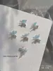 Nuevo taladro de uñas de circón Qiansi Mengdie decoraciones de alas de mariposa de doble ala tridimensionales para uñas venta al por mayor