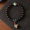 Hainan Semilla Dorada Cadena de Mano Grasa de Pollo Estrella Amarilla Luna Bodhi Madera de Durazno Flor de Loto Hombres y Mujeres Juego Cultural Pulsera de Cuentas Budistas Fabricante Mayorista
