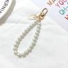 Versión coreana de cadena de perlas para cabeza de belleza retro llavero anillos para llaves redondos con letras para mujer adornos para bolso pequeños regalos al por mayor