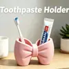 Portacepillos de dientes con forma de lazo estilo Ins, estante de doble tubo para lavabo, organizador de pasta de dientes y cepillos de dientes, herramienta organizadora rosa