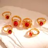 Anillo Abierto de Zirconia Roja Ovalada Electrochapado en Oro Real de 24 Quilates Anillo Transfronterizo Europeo y Americano Lujo Accesible Joyería de Alta Gama
