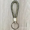 Llavero de cuerda de cuero trenzado simple creativo colgante de muñeca linda accesorios de llave para parejas tendencia regalos pequeños venta al por mayor