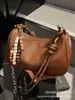 Bolso de axila retro de alta gama para mujer, nuevo y moderno bolso de hombro de nicho 2025 para el trabajo y los desplazamientos, bolso cruzado tipo dumpling