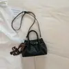 Bolso de mano tejido de estilo coreano de alta moda para mujer, otoño temprano 2026, bolso tote pequeño, bolso de hombro tipo cubo elegante y simple
