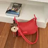 Bolsa de Cor Sólida com Textura Trançada Feminina Outono 2026 Nova Bolsa de Ombro Único Moda Bolsa de Mão Bolsa Transversal de Grande Capacidade Pingente