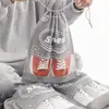 Artefacto de almacenamiento zapatos almacenamiento bolsa de zapatos no tejida a prueba de polvo a prueba de humedad moho arnés de viaje bolsa con cordón venta al por mayor en stock