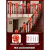 Un juego completo de artículos decorativos para una boda en una casa rural de construcción propia para los novios, incluyendo barandillas de escaleras, letreros festivos y decoraciones colgantes.
