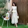 Suprimento Transfronteiriço 2025 Novo Estilo Moda Feminina Pequena Fragrância Gola Redonda Top Cintura + Conjunto de Saia