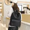 Mochila simple de color liso estilo japonés al por mayor del fabricante para ocio al aire libre, mochila de viaje de gran capacidad, mochila escolar para estudiantes