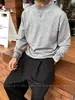 Suéter de punto negro de cuello alto medio estilo Old Money para hombre, versión coreana de invierno, top de capa interior cálido de alta gama