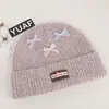 Gorro de punto estilo coreano, mezcla de lana, inspirado en la dopamina, con un lazo, diseñado para mujeres, que proporciona calidez y protección para los oídos en otoño e invierno, adecuado para estudiantes