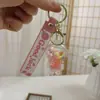Llavero de Botella de Arena Líquida de Dibujos Animados, Pequeños Regalos para Puestos, Accesorios Acrílicos al por Mayor, Colgante Relleno de Aceite, Rasca Gatos Lindo de Regalo