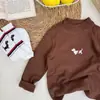 Nova camiseta infantil de manga comprida outono e inverno meninos e meninas camiseta básica de cachorrinho quente bebê top elástico camisa de malha