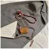 Bolso cruzado de hombro mini de nicho, bolsa para auriculares, bolso pequeño de moda retro, bolso de hombro exquisito de moda otoñal para mujer