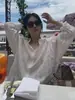 Ropa del mismo estilo de Song Hye-kyo, nueva camisa larga de manga larga suelta y ligera de primavera-verano, camisa protectora solar, camisa blanca de rayas verticales para mujer