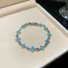 [Cadena de Diamantes Arcoíris] Pulsera de extracción de zircón trenzado en cruz, una pulsera lujosa y de alta gama, una pieza de joyería delicada y de moda