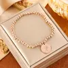 Pulsera elástica de cuentas redondas para mujer, Acero de titanio chapado en oro de 18 quilates, Colgante de moneda de alta gama, Joyería de pulsera versátil de estilo de lujo ligero