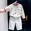 Estilo Coreano Niños 2026 Otoño Nueva Moda Caricatura Letra Bloque de Color Suéter de Punto Pantalones Casuales Blancos Infantiles Modernos