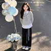 Conjunto de duas peças estilo colegial para meninas mais velhas, apresentando um top patchwork e calça casual xadrez com blocos de cor, um look versátil e moderno