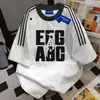 Camiseta Popular Americana con Estampado de Letras y Tres Rayas de Manga Corta para Hombres y Mujeres, Top Holgado Chic de Verano 2025