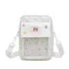 Bolso bandolera versátil de estilo nuevo de dibujos animados para niñas, lindo bolso transparente con insignia de pin, bolso simple para teléfono, bolso mini pequeño para mujer