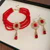 Aretes y Collar de Gota de Agua Incrustados con Diamantes Rojos de Año Nuevo, Accesorios Versátiles de Lujo Ligero de Nicho, Juego de Joyería de Alta Gama para Mujer al por Mayor