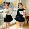 Nueva colección de Primavera y Otoño: Camisetas básicas de manga larga con cuello redondo para niñas, con lindos estampados de moños, disponibles al por mayor