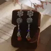 Pendientes Largos Personalizados de la Fábrica Jinqi Estilo Chino Nuevo Flor Pequeña Hueco Azul Quemado Borla para Mujer Pendientes Estilo Étnico Vintage