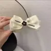 Horquilla elegante de lazo de camelia, pasador retro exquisito para la parte trasera de la cabeza, clip versátil, estilo pequeño y fragante, clip de alta calidad para coleta