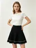 Venta al por mayor transfronteriza desde la fábrica de origen: falda corta de punto para mujer de cintura alta, línea A, con pliegues y bordado color block, estilo europeo y americano
